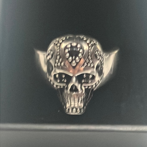 silver with black accented diamonds for eyes a small ruby ontop of the head